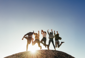 groupe de personne qui saute de joie en contre jour